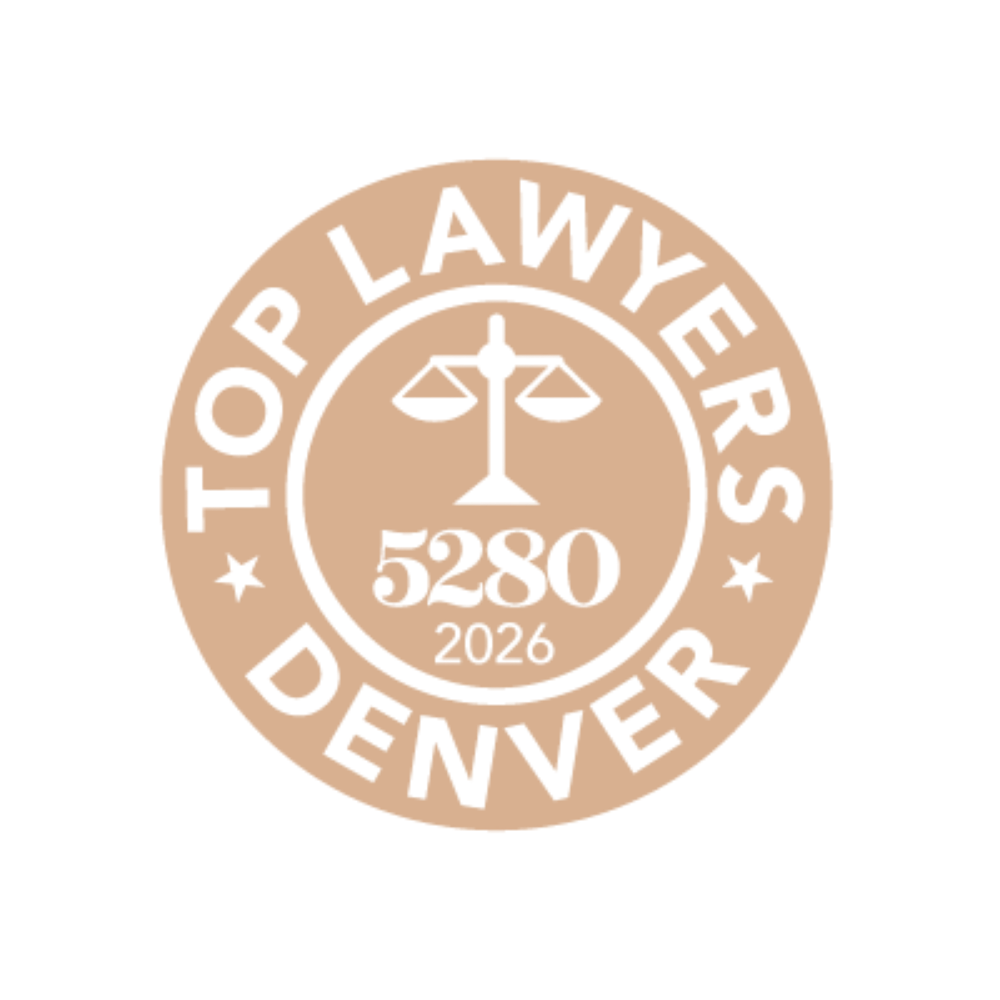 Circular ‘Top Lawyers Denver 5280 2026’ badge featuring a scales of justice icon in the center, with tan and white color scheme.