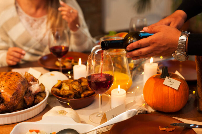 Pouring wine next to Thanksgiving meal - Thanksgiving and Drunk Driving