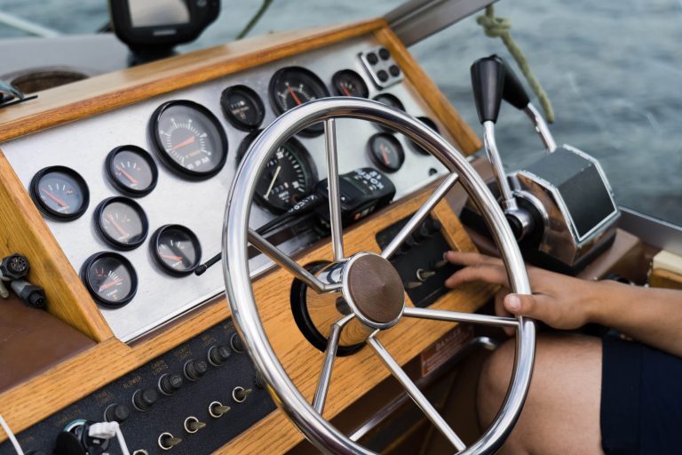 Captain at the helm of an old yacht, dashboard.